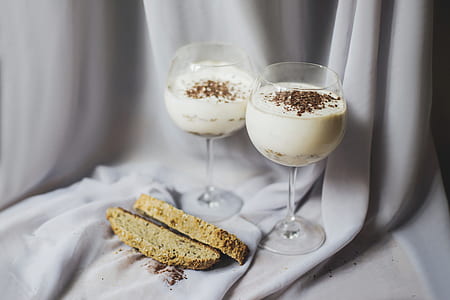 two clear long-stemmed drinking glasses with sliced of bread thumbnail