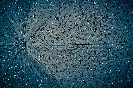 blue umbrella covered with water dews thumbnail