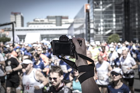 Person Hoding Camera Taking Photo of People thumbnail