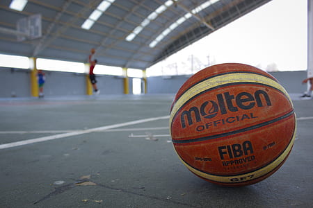 red and white Molten basketball on court thumbnail
