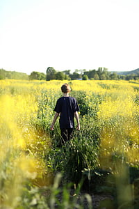 boy walking on grass field thumbnail