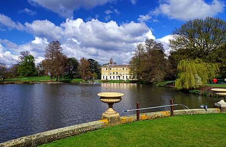 beige house beside body of water thumbnail