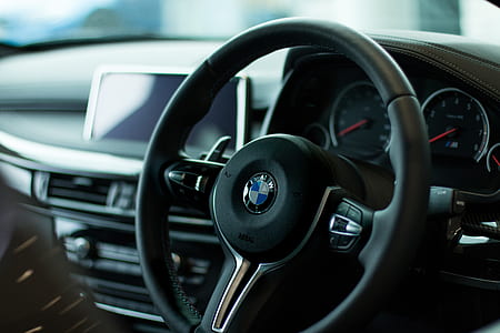 shallow focus photography of black BMW steering wheel thumbnail