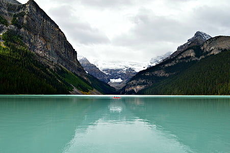 overlooking view of mountains and body of water under cloudy sky thumbnail