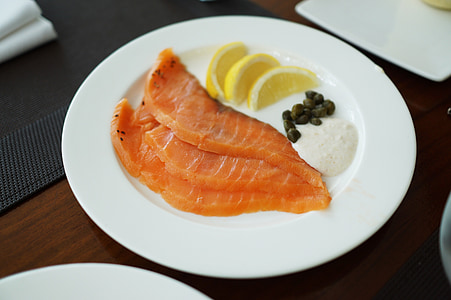salmon slices placed on placed above table thumbnail
