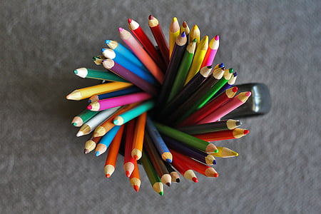 top-view photography of assorted-color pen in mug thumbnail