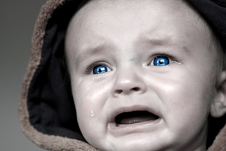 Teardrop from crying baby with blue eyes thumbnail