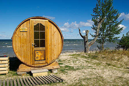 round brown wooden shed near body of water thumbnail