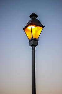 black outdoor post light over blue sky thumbnail