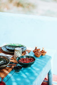 bowl beside cup on blue table thumbnail
