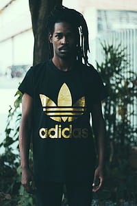 man wearing black and gold Adidas crew-neck t-shirt thumbnail