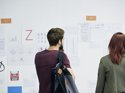 man in maroon shirt beside woman in gray jacket thumbnail