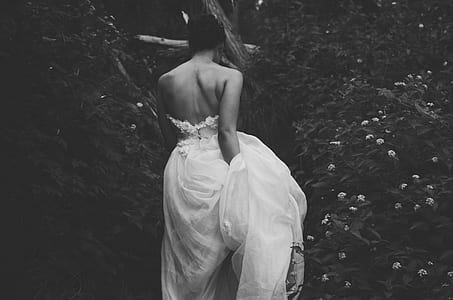 grayscale photography of woman with wedding dress near plants thumbnail