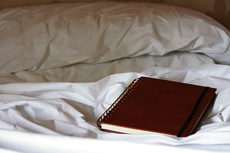 red spring book on top of bed inside the room thumbnail