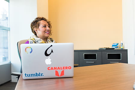 Woman Sitting Near Silver Apple Macbook thumbnail