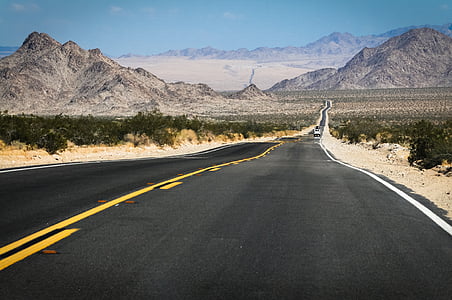 grey concrete road under blue sky thumbnail