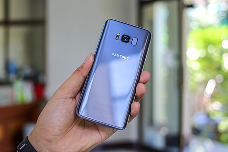 person holding blue Samsung Galaxy S8 thumbnail
