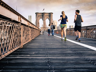 people on brown and black Brooklyn bridge during daytime thumbnail