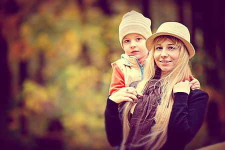 selective focus of photography of woman holding boy thumbnail