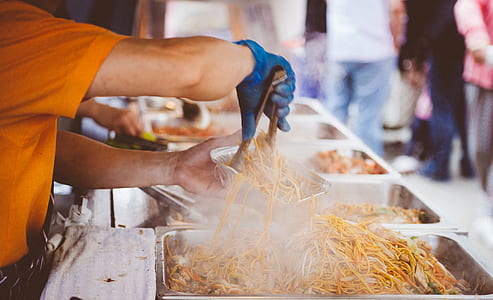 man pouring noodles on bowl thumbnail