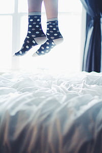 person wearing socks jumping on mattress thumbnail