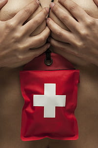 person wearing red and white cross pouch thumbnail