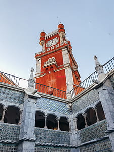 Low Angle Photography of Red and Grey Concrete Building Under Blue Sky thumbnail