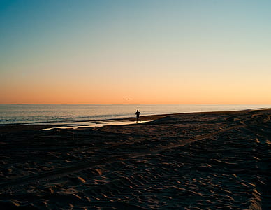 person running on seashore at daytime thumbnail
