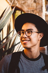 smiling man wearing black hat and eyeglasses thumbnail