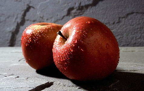 two red apples on gray stone thumbnail