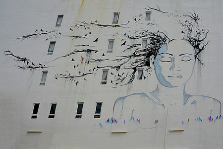 woman's portrait painted on white high-rise building thumbnail