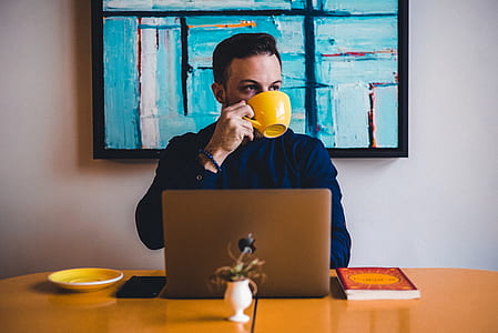 man wearing blue dress shirt and holding yellow mug thumbnail