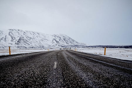 empty roadway under cloudy sky thumbnail