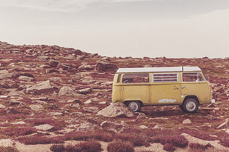 brown and white Volkswagen T2 on rocky road thumbnail
