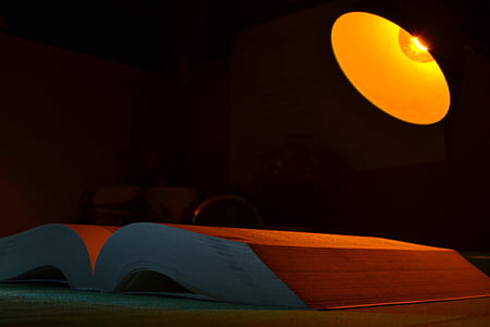 opened book beside lighted on lamp thumbnail