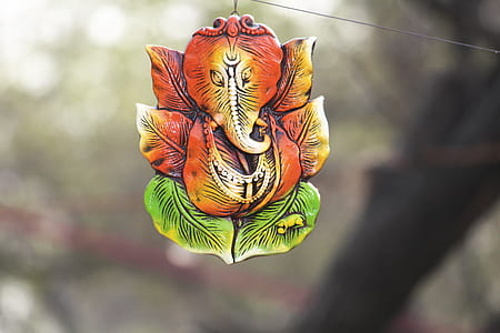 selective focus photography of orange elephant decor thumbnail