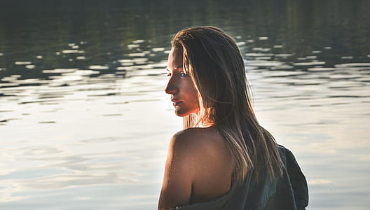 woman standing in front of body of water thumbnail