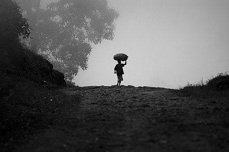 gray-scale of man holding a rice sack thumbnail