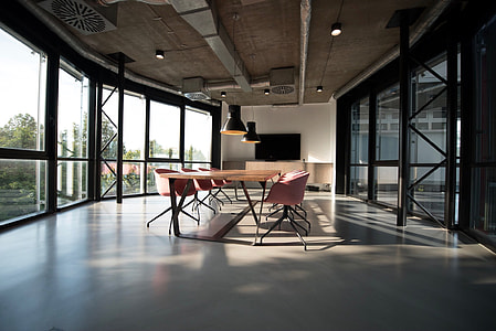 minimalist photography of office table inside glass room thumbnail