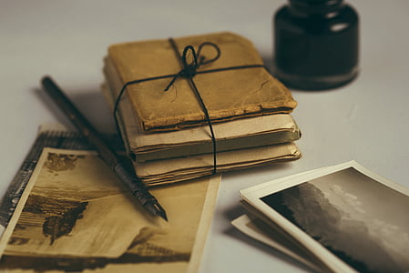 shallow focus photography of book and ink pen thumbnail
