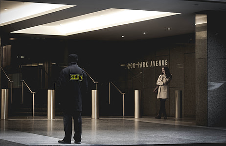 woman and security guard standing inside hall thumbnail