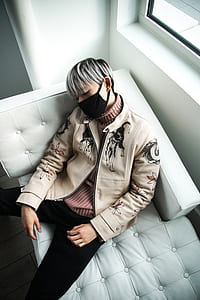 man sleeping on tufted white couch thumbnail