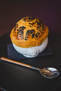 Pastry on White Cup Beside Silver Spoon thumbnail