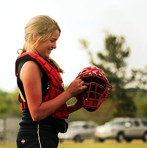girl holding red and black helmet and wearing red vest thumbnail
