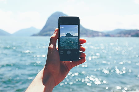 Person Taking Photo of Mountain thumbnail