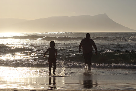 man and boy barefoot on sea thumbnail