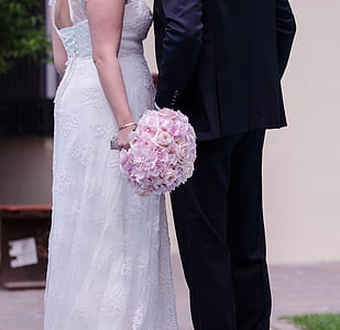 wedding couple standing near wall thumbnail