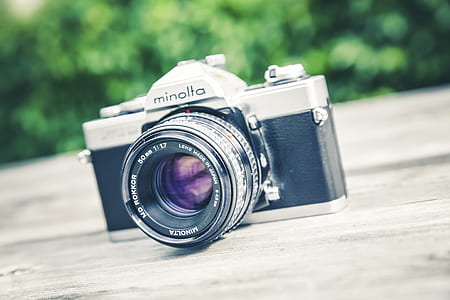 black and gray Minolta camera on table thumbnail