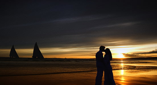 silhouette couple kissing near beach thumbnail