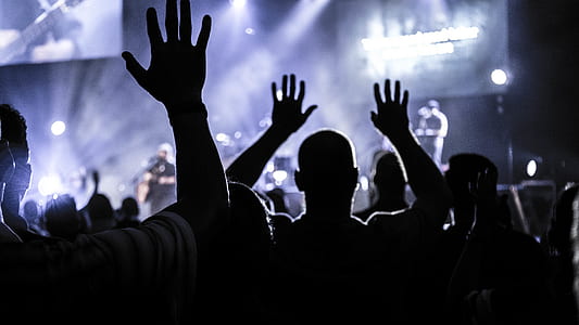 silhouette of people raising hands facing band thumbnail